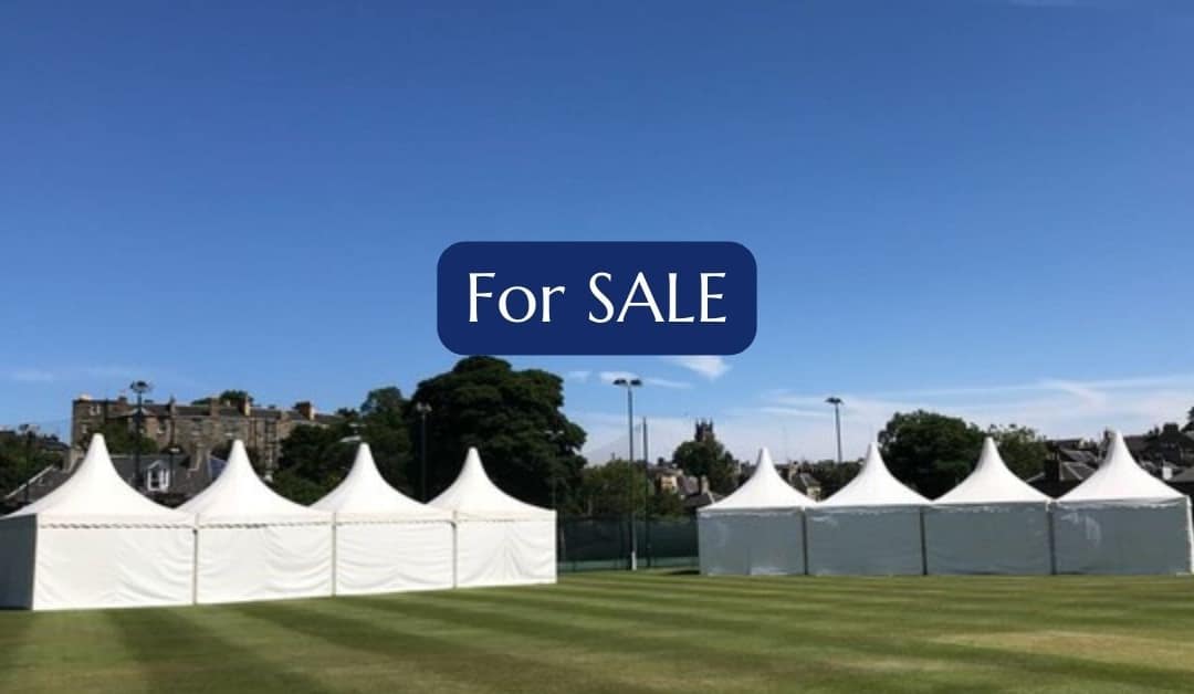 Pagoda tents in front of a stately home on a summers day